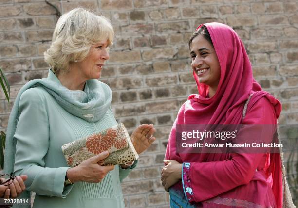 Camilla, Duchess of Cornwall, wearing a traditional Shalwar Kameez, chats to a student at the all female Fatima Jinnah University on the third day of...
