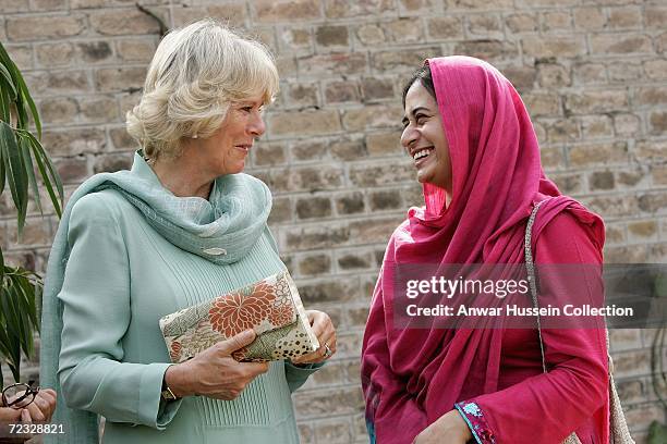 Camilla, Duchess of Cornwall, wearing a traditional Shalwar Kameez, chats with a student at the all female Fatima Jinnah University on the third day...