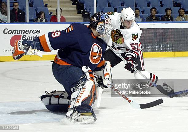 Rick DiPeitro of the New York Islanders defends against Karl Stewart of the Chicago Blackhawks on October 31, 2006 at Nassau Coliseum in Uniondale,...
