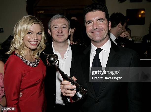 Music producers Louis Walsh and Simon Cowell pose with TV presenter Kate Thornton at the party following the National Television Awards 2006 at the...