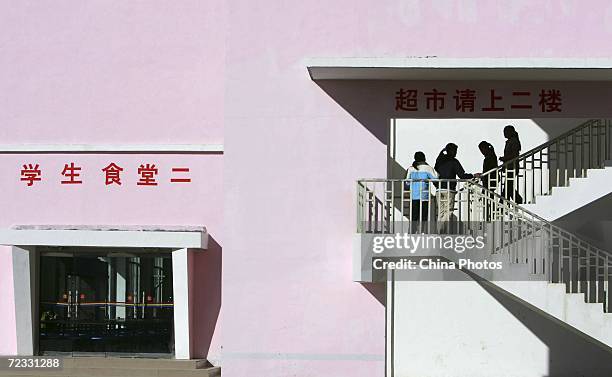 Tibetan students go upstairs to a supermarket at Nyingchi First High School, the only high school of Nyingchi Prefecture, on October 29, 2006 in...