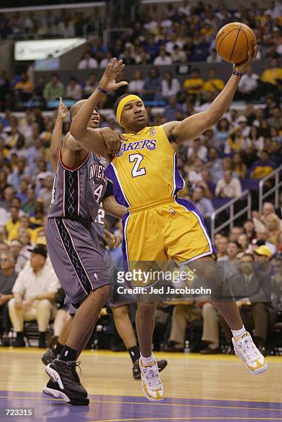 Derek Fisher of the Los Angeles Lakers goes to the basket past Richard Jefferson of the New Jersey Nets during Game one of the 2002 NBA Finals at...