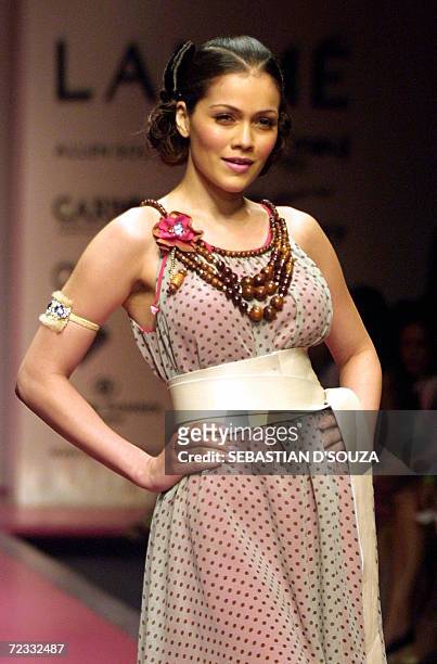 An Indian model displays designer Surily Goel's collection on the second day of Lakme Fashion Week at the National Center for Performing Arts in...