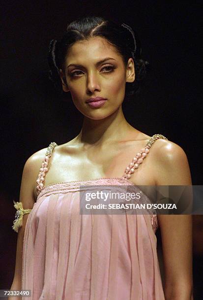 An Indian model displays designer Surily Goel's collection on the second day of Lakme Fashion Week at the National Center for Performing Arts in...