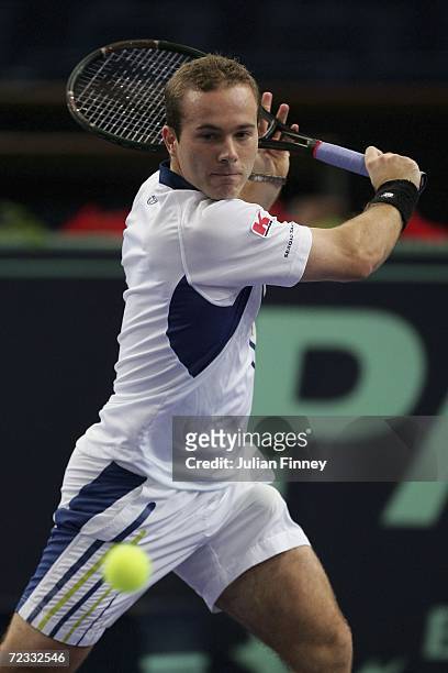 Olivier Rochus of Belgium plays a backhand in his match against Tomas Berdych of Czech Republic during day three of the BNP Paribas ATP Tennis...