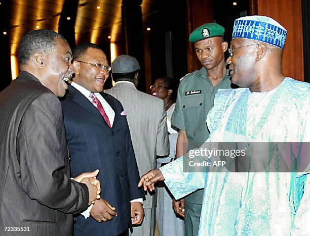 Vice President Atiku Abubakar talks with Osita Ogbu , Economic Adviser to the President, and Simeon Ogunniyi, special assistant to the chief of staff...