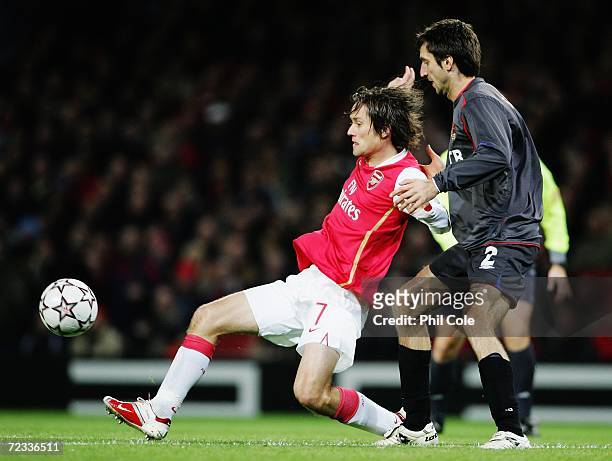 Tomas Rosicky of Arsenal holds off the challenge of Deividas Semberas of CSKA Moscow during the UEFA Champions League Group G match between Arsenal...