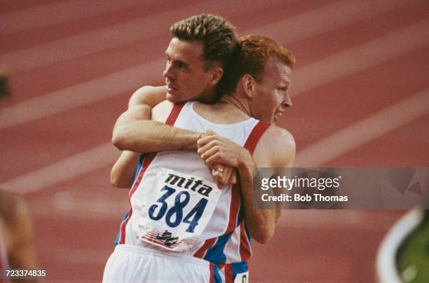 Tom McKean of Great Britain, gold medallist, hugs his team-mate David Sharpe who won the silver medal in the men's 800m final at the 15th European...