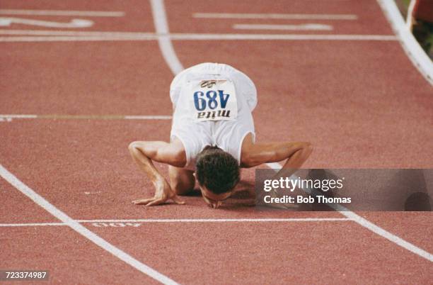 Salvatore Antibo of Italy kisses the track after finishing in first place to win the gold medal in the men's 10,000m event final at the 15th European...