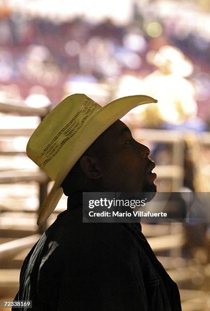 An African-American cowboy looks at a list to find out what horse he drew for Bronco Horse finals of National Black Rodeo Finals on November 13, 2004...