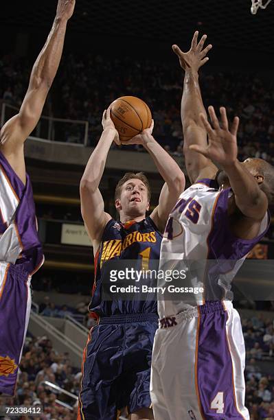 Forward Troy Murphy of the Golden State Warriors shoots over forward Alton Ford of the Phoenix Suns during the NBA game at America West Arena in...