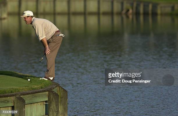 Hal Sutton lines up his putt on the par three 17th hole after his tee shot went in the water during the third round of the Tournament Players...