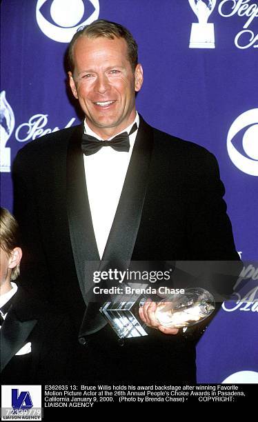 Bruce Willis holds his award backstage after winning Favorite Motion Picture Actor at the 26th Annual People's Choice Awards in Pasadena, California...