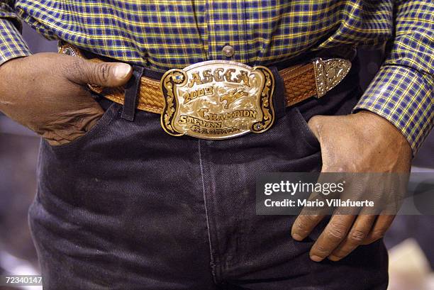 Steven Gabriel of Houston, Texas wears a gold and silver cowboy belt buckle from the National Black Rodeo Finals on November 13, 2004 at the...