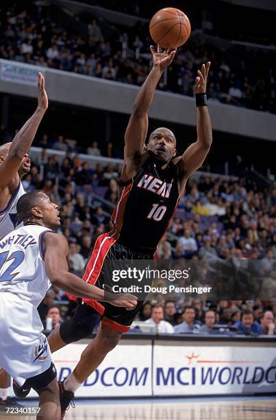 Tim Hardaway of the Miami Heat leaps for the basket as he is guarded by Chris Whitney of the Washington Wizards at the MCI Center in Washington, D.C....