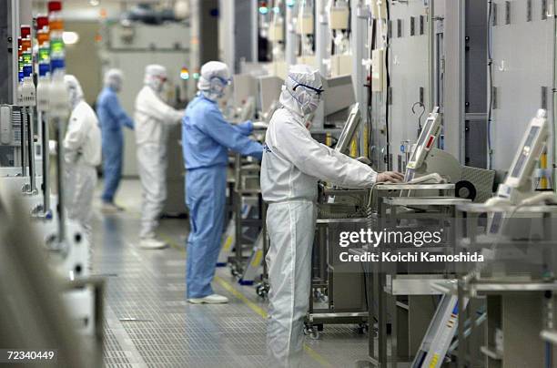 Technicians at work in the clean room of the Fab Equipment at a semiconductor company, Renesas Technology Corp. On June 17, 2004 in Ibaraki, Japan....