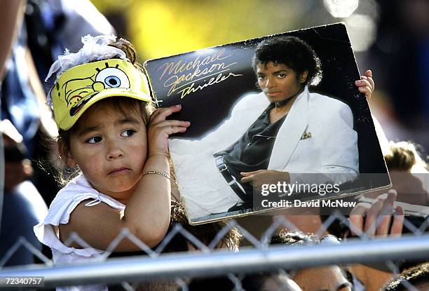 Three-year-old Bridget Yruegas of Santa Maria, California holds a copy of singer Michael Jackson's 'Thriller" album outside the courthouse during his...