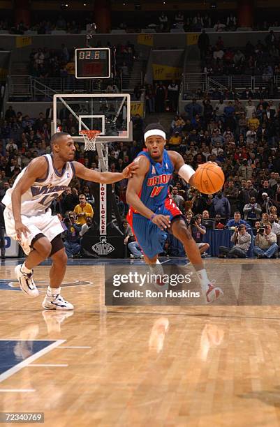 Damon Jones of the Detroit Pistons dribbles the ball upcourt against Chris Whitney of the Washington Wizards at the MCI Center in Washington, D.C....