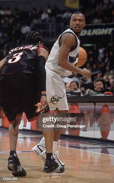 Guard Chris Whitney of the Washington Wizards dribbles the ball as point guard Allen Iverson of the Philadelphia 76ers plays defense during the NBA...