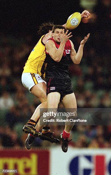Russell Robertson for Melbourne marks infront of Trent Croad for Hawthorn during the round 19 AFL match played between the Melbourne Demons and the...