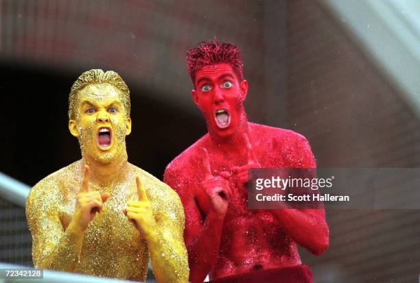 View of two fans of the Florida State Seminoles who paint their bodies in the school colors for support during the game against the Louisiana Tech...