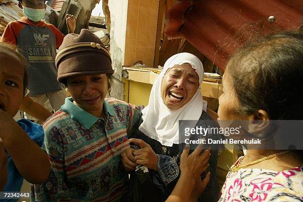 Family mourn the loss of loved ones during rescue operations on March 30, 2005 in Nias, Indonesia. An earhquake measuring 8.5 on the Richter scale...