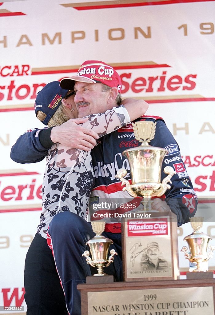 Dale Jarrett hugs his wife Kelly as he stands with the winning trophy