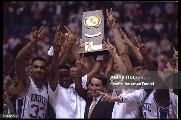 Head coach Mike Krzyzewski and his Duke Blue Devils revel in their glory after winning their second consecetive NCAA basketball championship by...