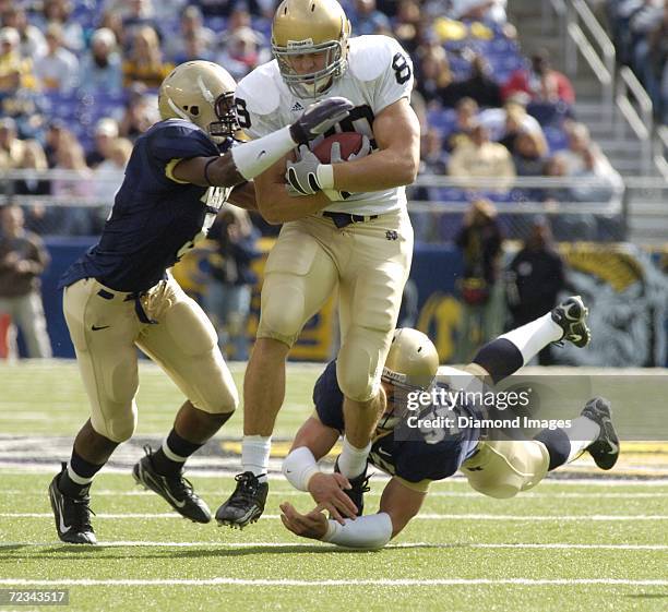 Tight end John Carlson, of the University of Notre Dame Fighting Irish, catches a pass in front of safety Jeromy Miles and linebacker Rob Caldwell,...