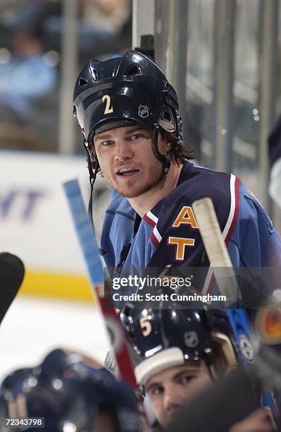 Garnet Exelby of the Atlanta Thrashers puts on the rally cap as he wears his helmet backwards for the shootout against the Washington Capitals during...