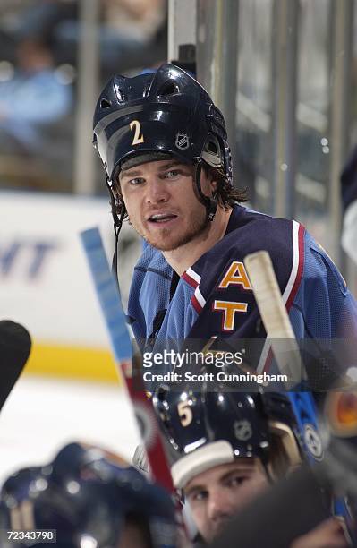 Garnet Exelby of the Atlanta Thrashers puts on the rally cap as he wears his helmet backwards for the shootout against the Washington Capitals during...