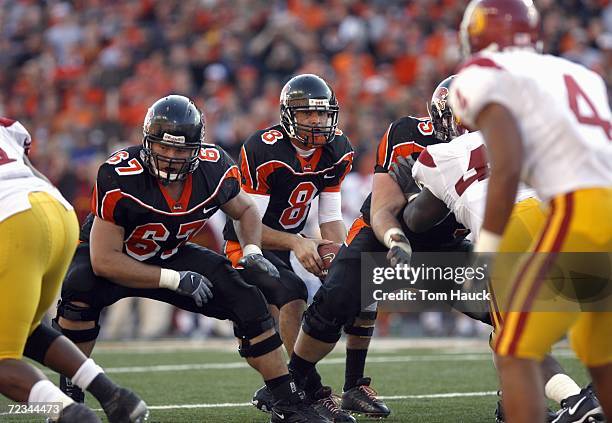 Matt Moore of the Oregon State Beavers at the line of scrimmage with Roy Schuening during the game against the Southern California Trojans at Reser...