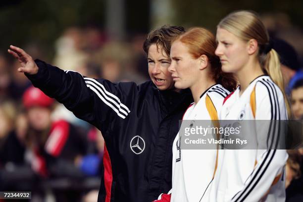 Coach Maren Meinert of Germany gives instructions to her players Christina Schellenberg and Marie Pollmann during the women's U19 international...