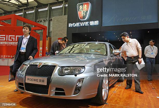 Chinese visitors view a Chinese-made Roewe car from the SAIC Motor Corp at the China International Industry Fair in Shanghai, 02 November 2006. SAIC...
