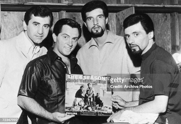 Italian-American vocal group The Four Seasons with their album 'The 4 Seasons' Gold Vault Of Hits', which has gone gold after a million dollars in...