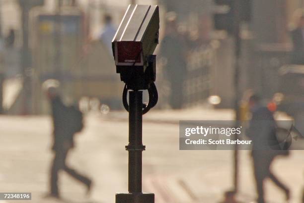 People walk down a street as a camera watches on Novemebr 2, 2006 in London, England. Richard Thomas, the British government's information...