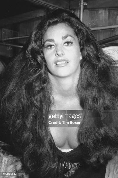 Portrait of American actress Edy Williams, leaning forward as she poses in a meat market, New York, New York, mid 1971. She is likely in New York for...