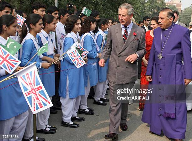 Britain's Prince Charles walks with Bishop of Lahore Alexandar Johan Malik past a row of schoolgirls during a visit to Cathedral Church in Lahore, 02...