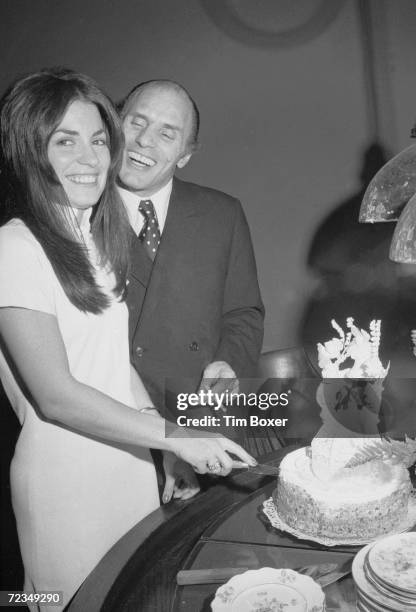 American gangster Joe Gallo , also known as Crazy Joey, smiles as his wife Sina Essary cuts the cake at their wedding reception, New York, New York,...
