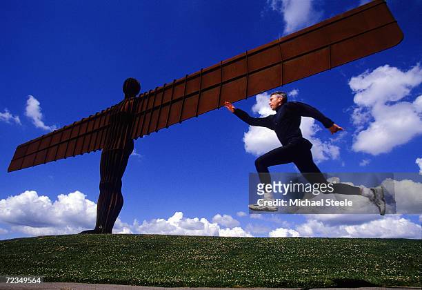 Olympic and World Triple Jump Champion and World Record holder Jonathan Edwards takes a jump at the Angel of the North Sculpture in Gateshead, Great...