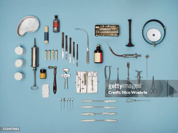 directly above shot of medical tools on blue background - vintage syringe stock pictures, royalty-free photos & images
