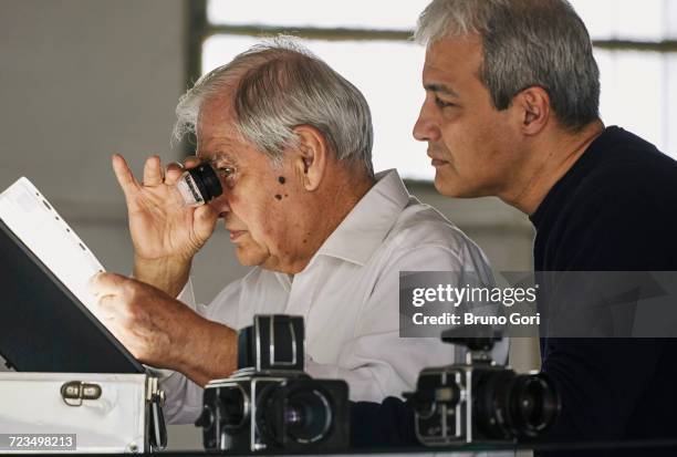 father and son looking at sheet of film slides - gifted film ストックフォトと画像