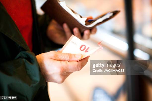 cropped view of woman holding a banknote and purse - french budget stock pictures, royalty-free photos & images