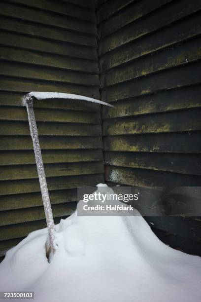 ice axe in snow against wall - ice pick stock-fotos und bilder