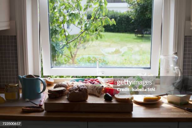 food on table by window - window ajar stock pictures, royalty-free photos & images