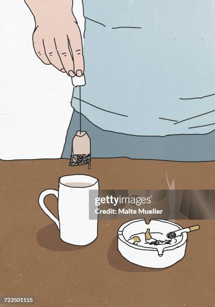 ilustrações, clipart, desenhos animados e ícones de illustration of man holding teabag above cup by ashtray on table - banhando