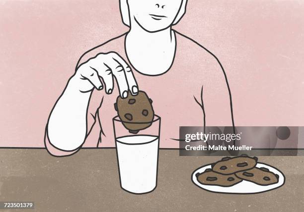 midsection of woman dunking cookie in milk at table against colored background - dipping stock-grafiken, -clipart, -cartoons und -symbole