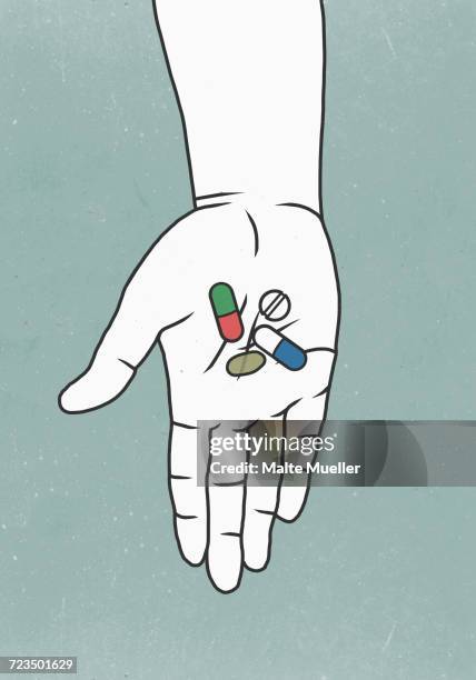 illustrations, cliparts, dessins animés et icônes de close-up of person holding medicine against colored background - hand holding several pills