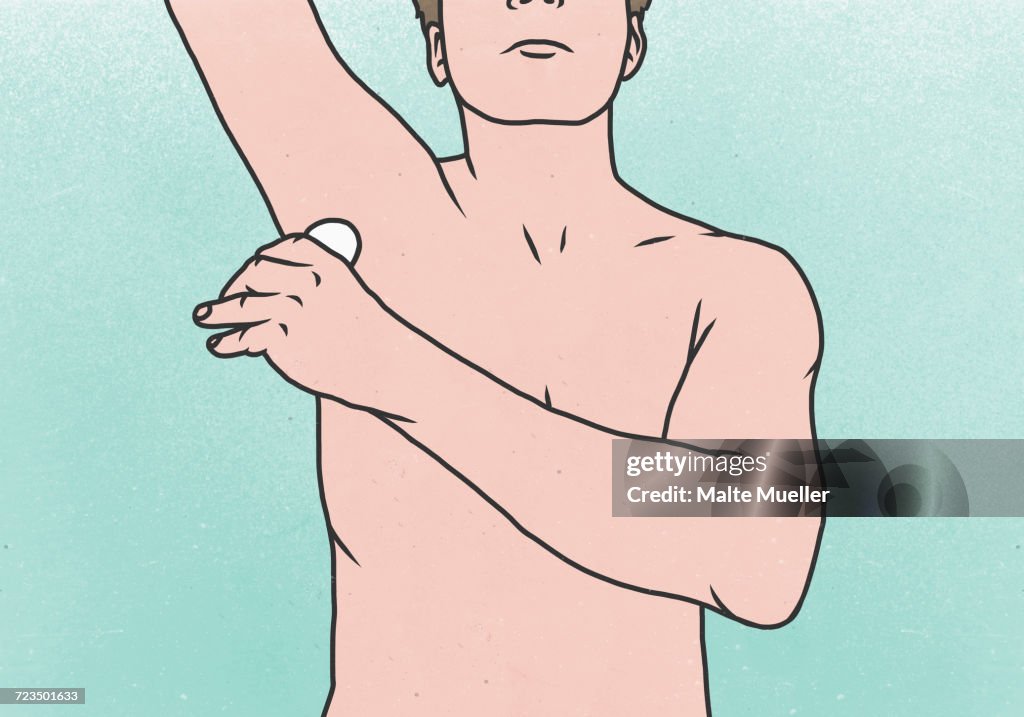 Midsection of man applying deodorant under armpit against colored background