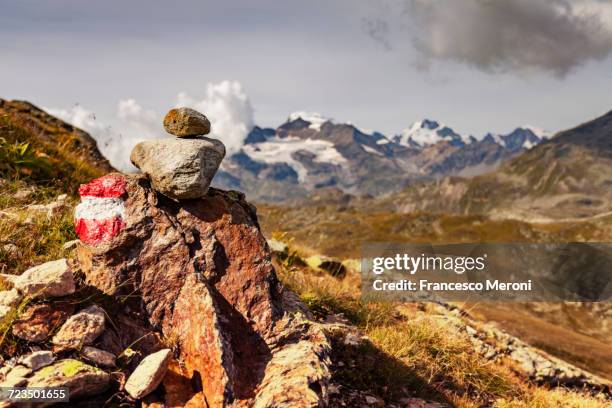 stack of painted rocks, view of mountains - steinpyramide stock-fotos und bilder